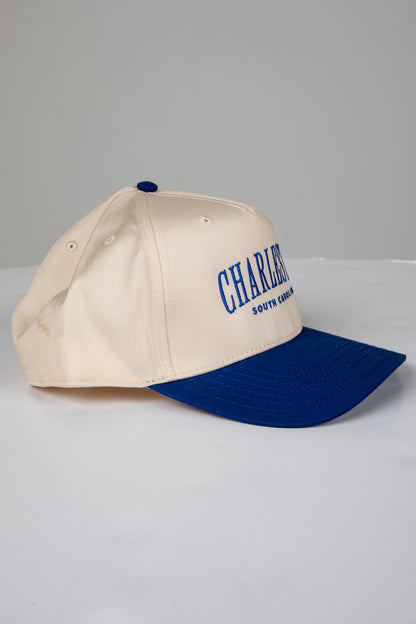 Beige and blue cap with &