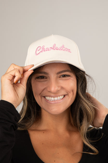 Woman wearing a white cap with &