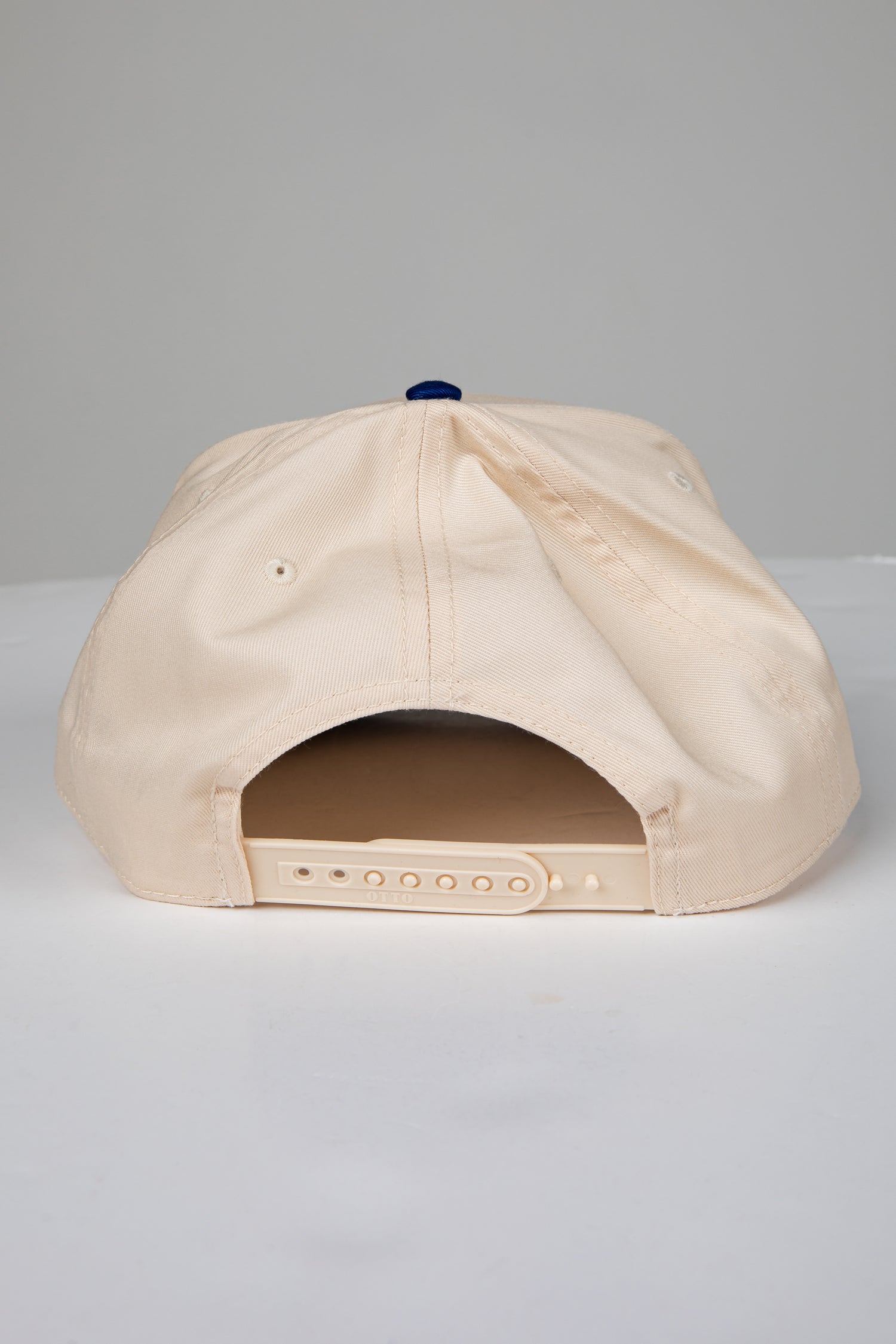 Beige baseball cap on a light gray background