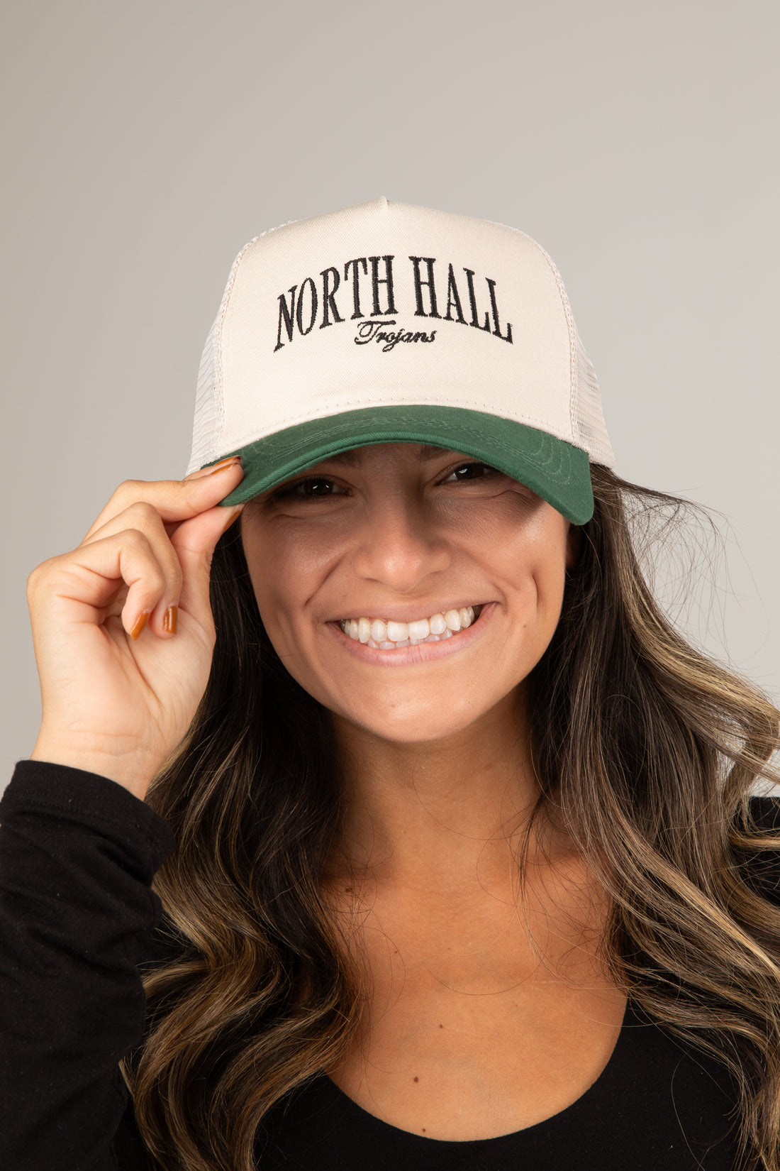 Person wearing a white cap with &