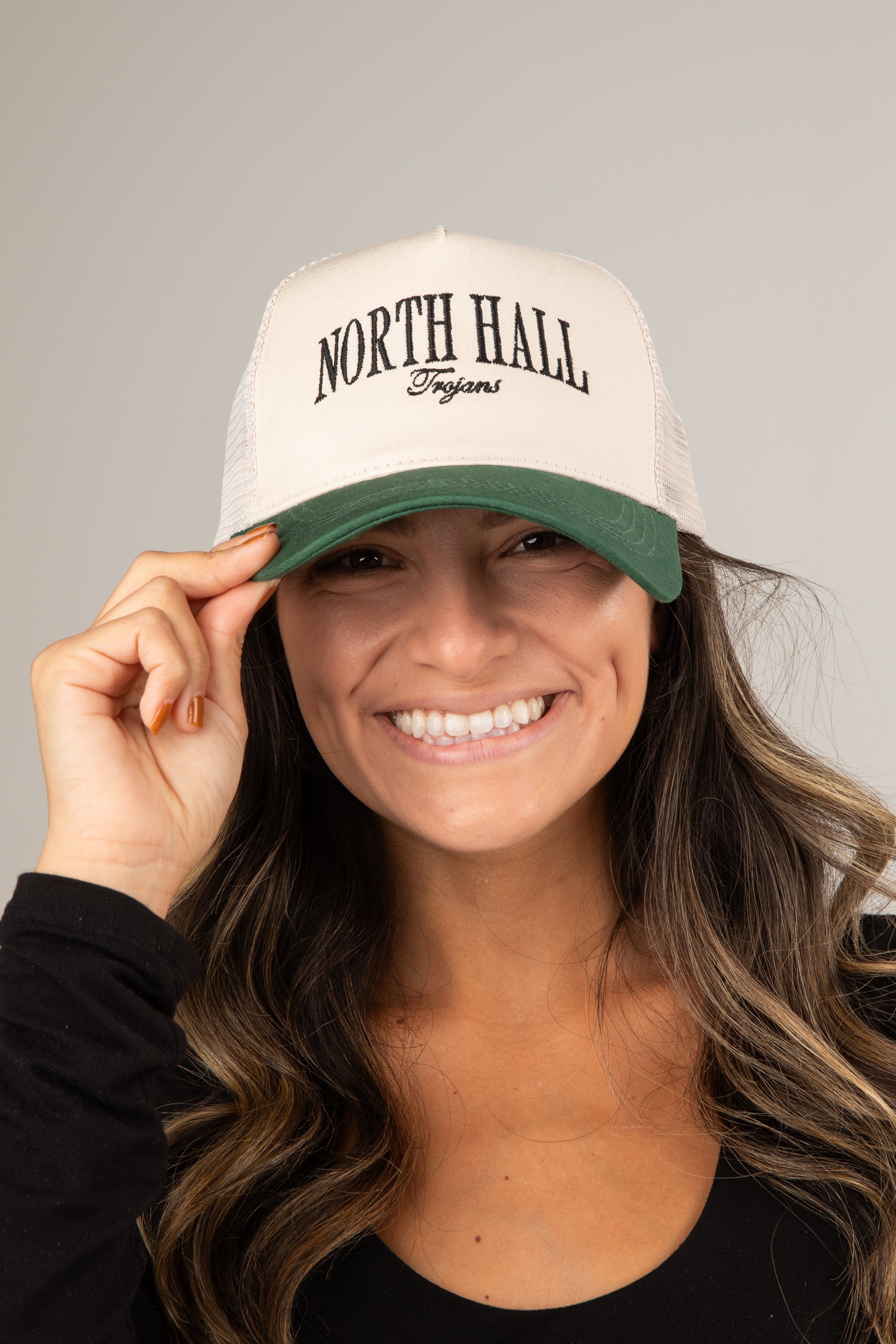 Person wearing a white cap with &