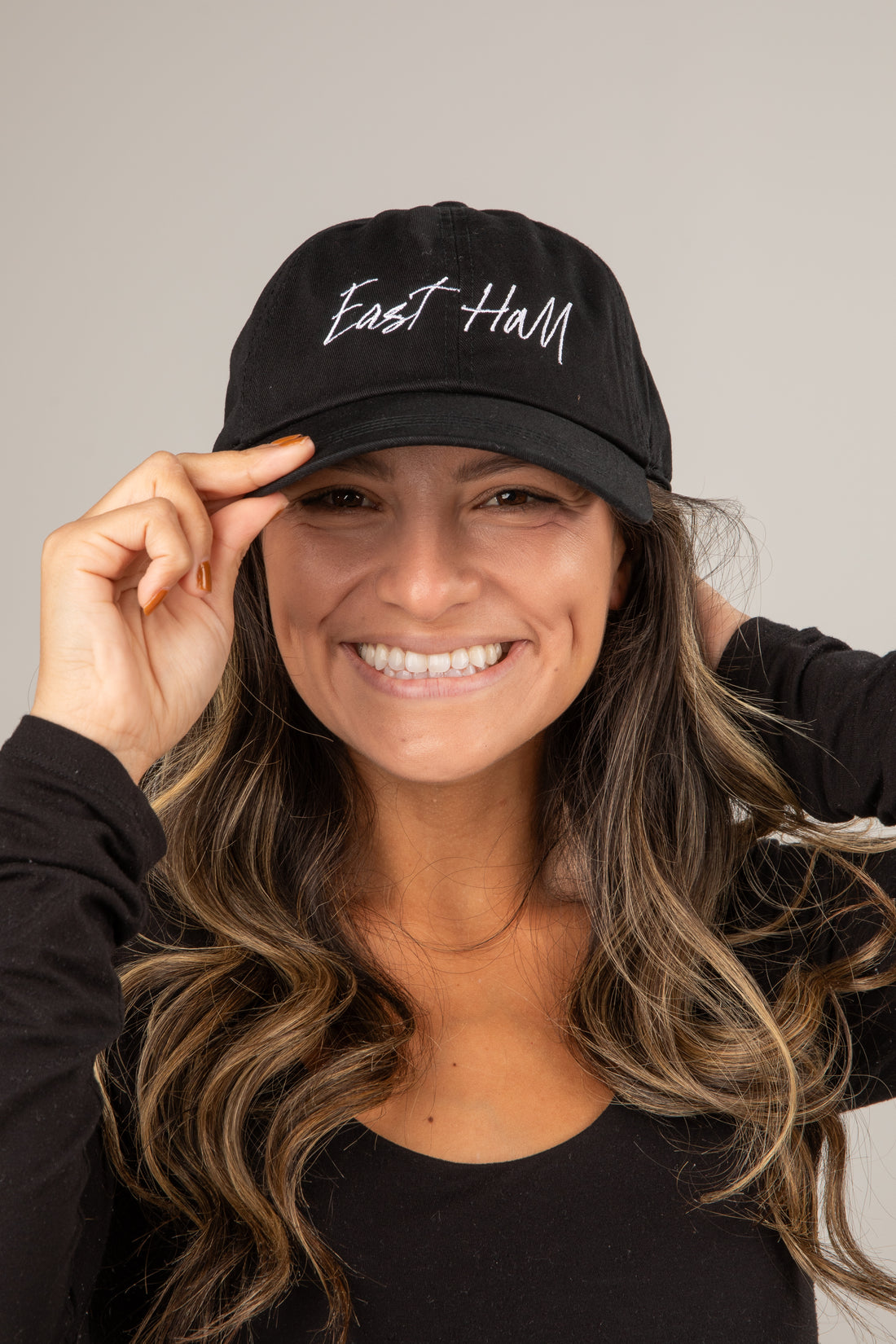 Woman wearing a black cap with &