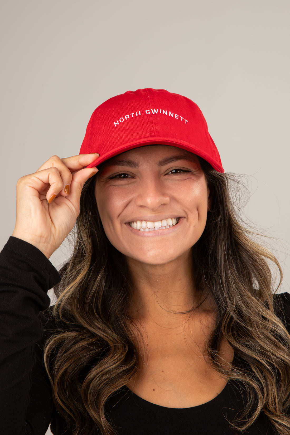 Person wearing a red cap with &