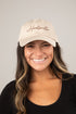 Woman wearing a beige cap with &