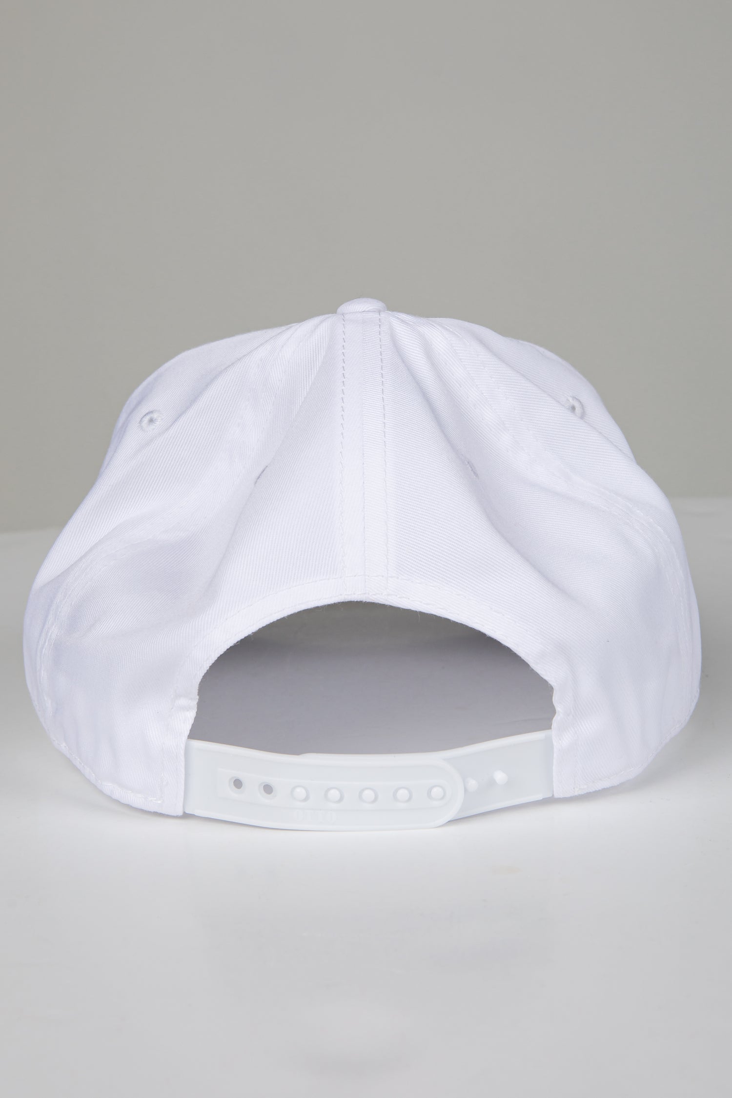 White baseball cap on a light gray background