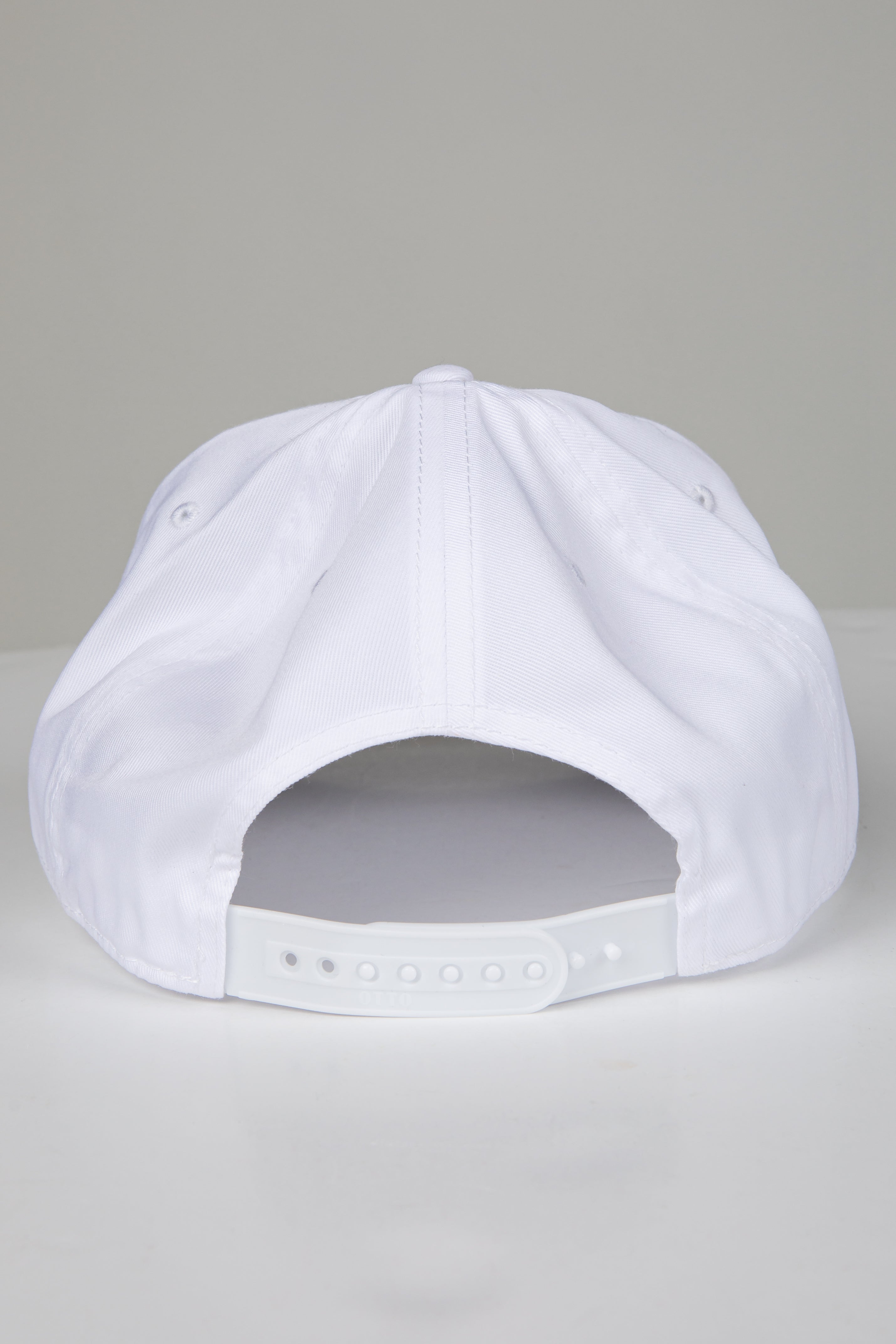 White baseball cap on a light gray background