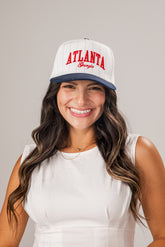 Woman wearing a white cap with &
