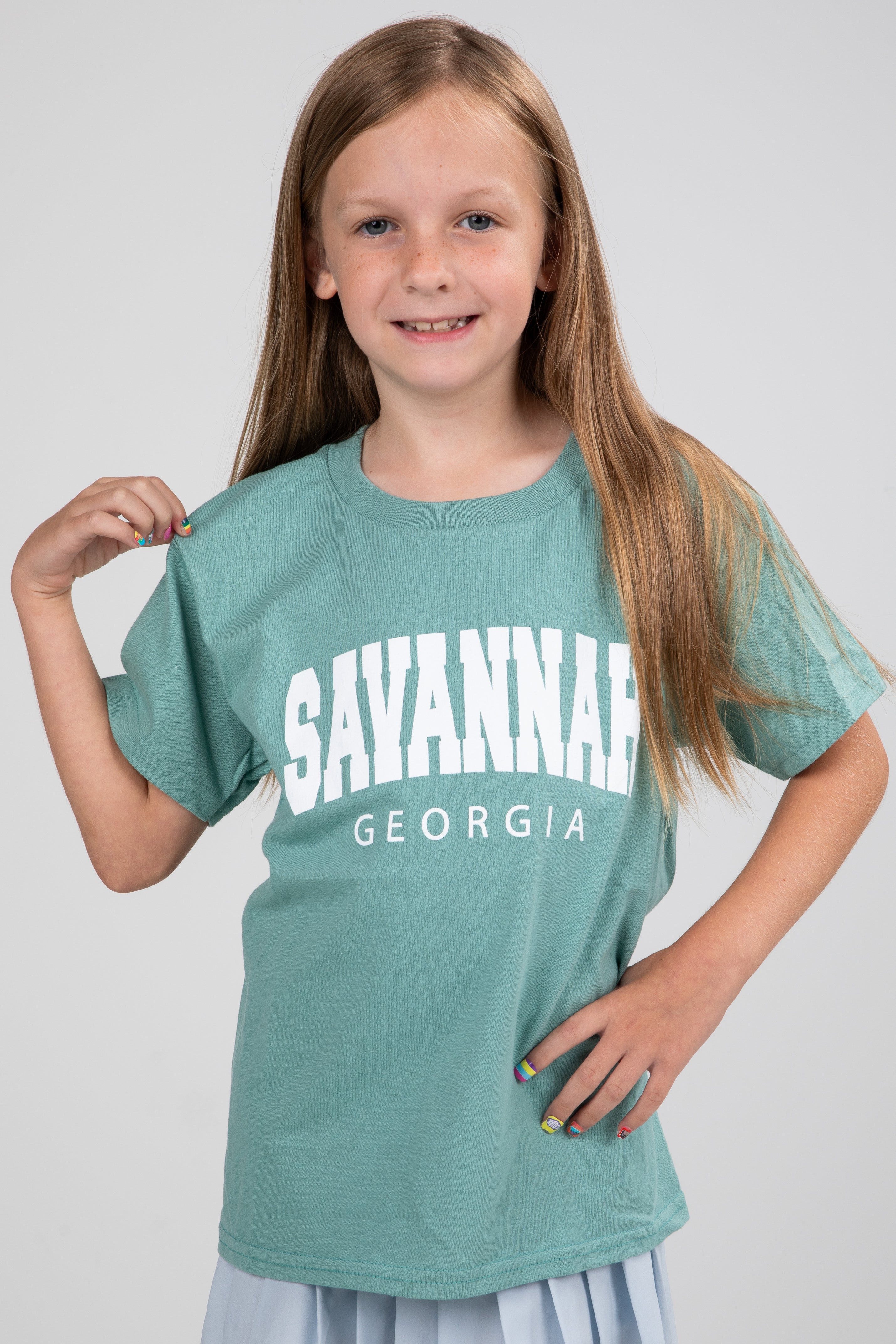 Girl wearing a teal t-shirt with &