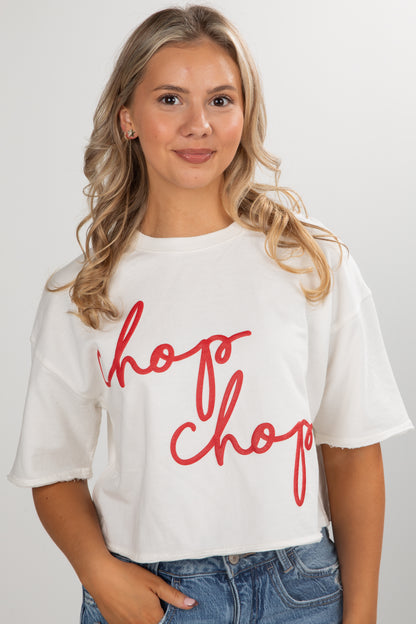 Woman wearing a white t-shirt with red text on a plain background