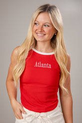 Woman wearing a red tank top with &