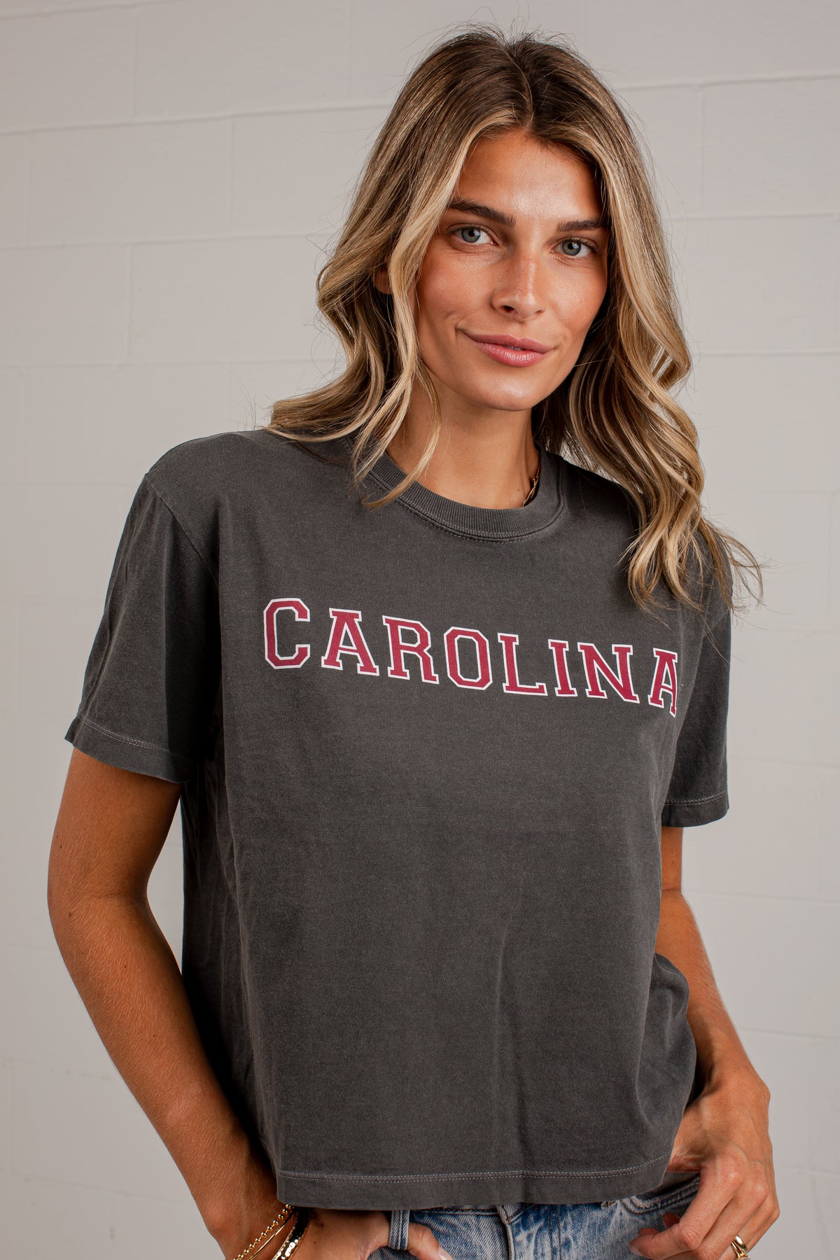 A woman wearing a dark gray washed t-shirt with &