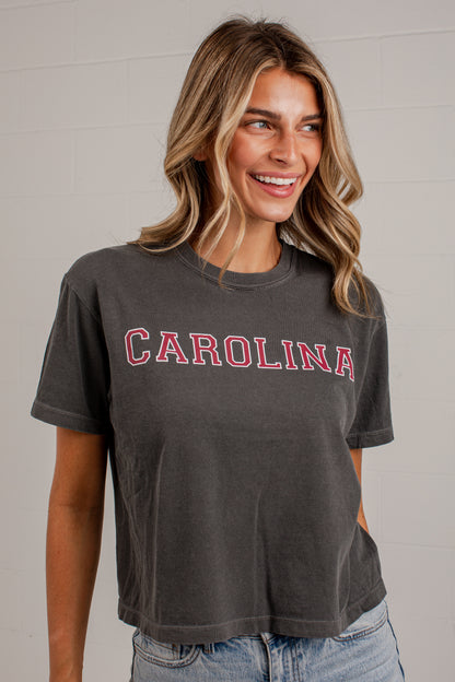 A woman wearing a dark gray washed t-shirt with &