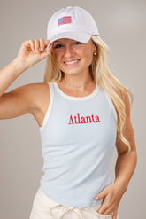 Woman wearing a white tank top with &