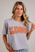 A woman wearing a heather gray Clemson Tigers graphic t-shirt with &
