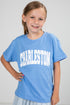 Young girl wearing a blue t-shirt with &