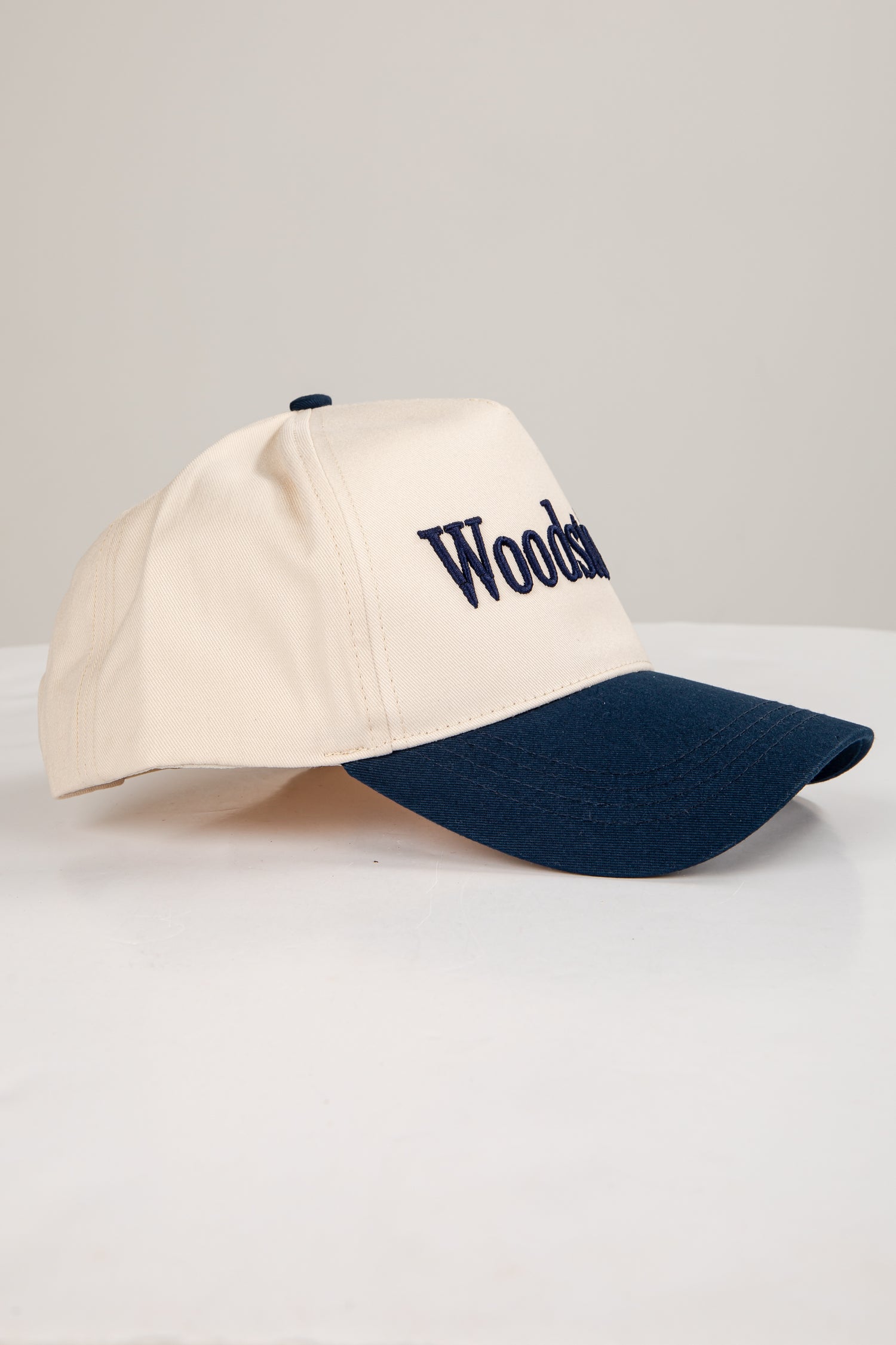 Beige and navy cap with &