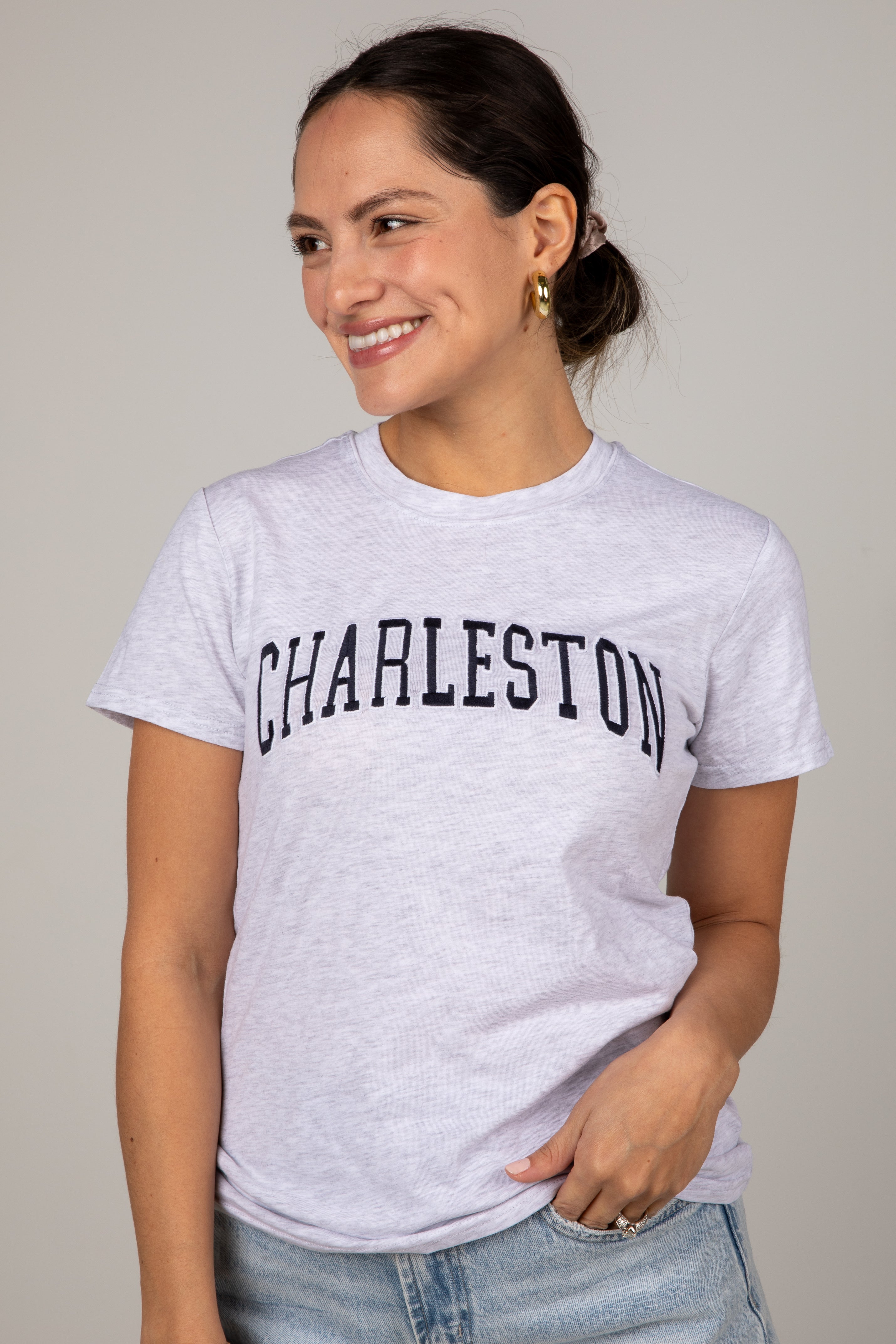 Woman wearing a gray t-shirt with &