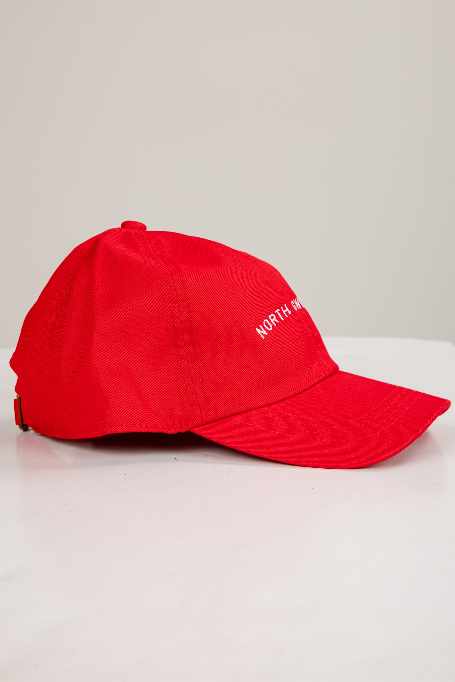 Red cap with white text on a light gray background