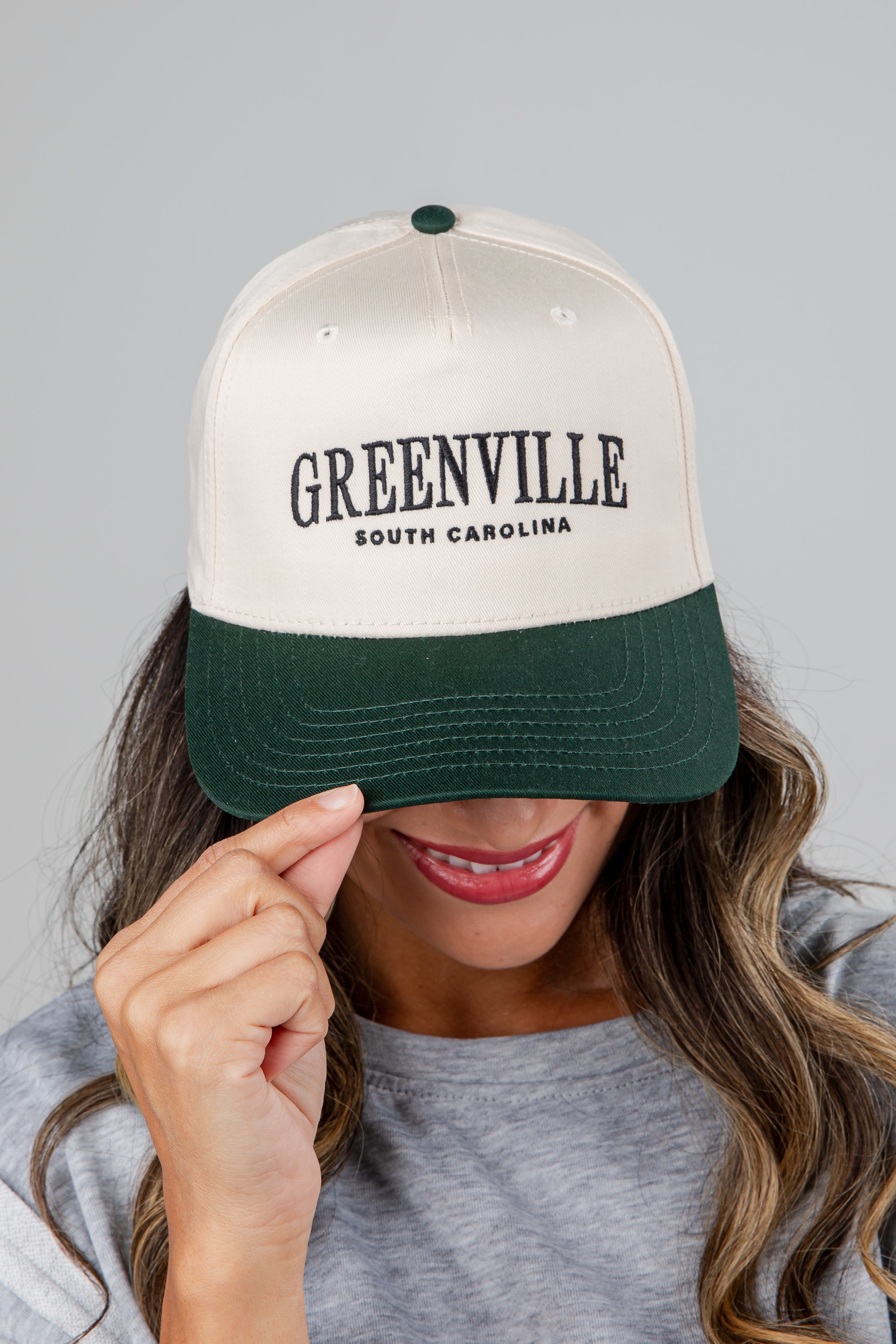 Person wearing a cap with &