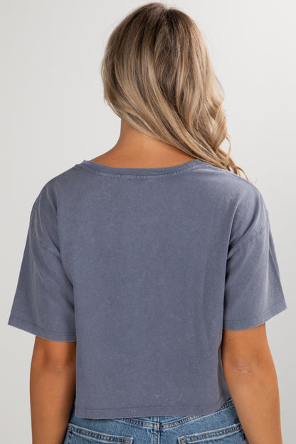 Person wearing a blue t-shirt and jeans on a plain background