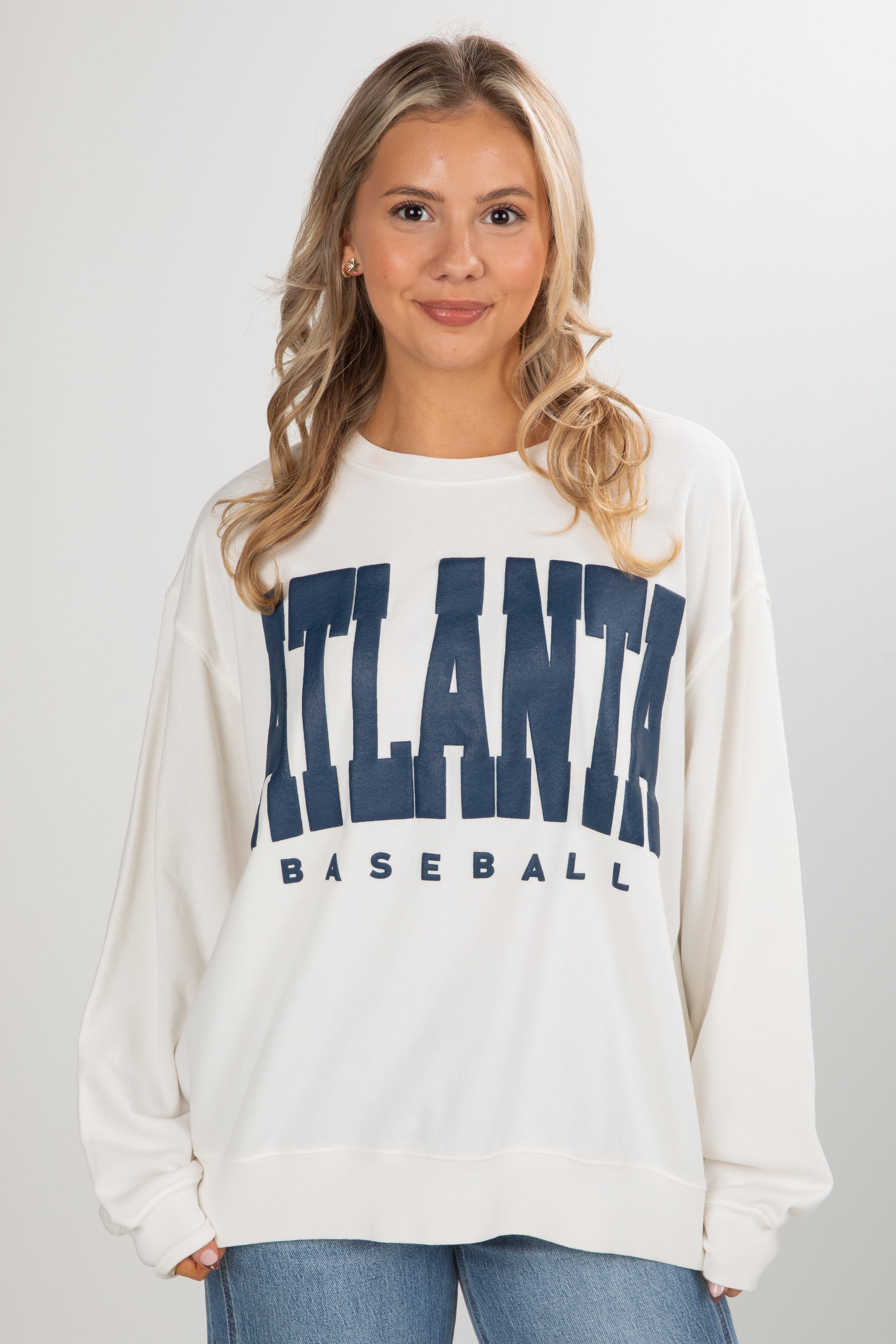 Woman wearing a white sweatshirt with &