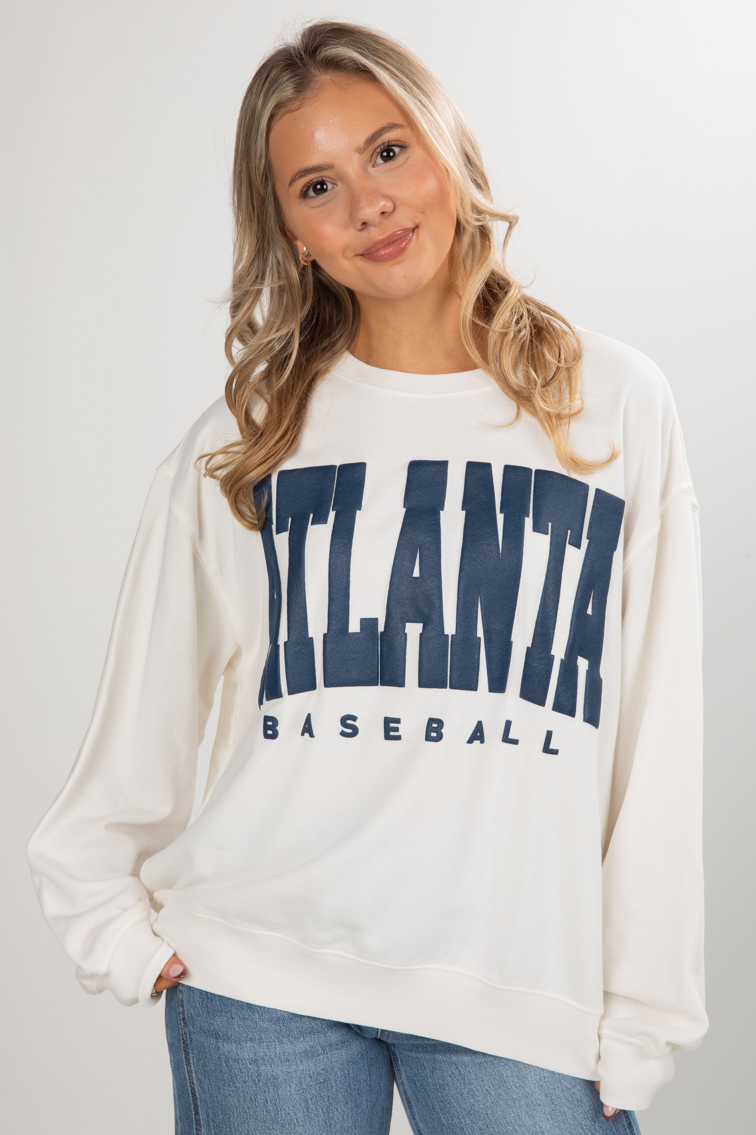 Woman wearing a white sweatshirt with &