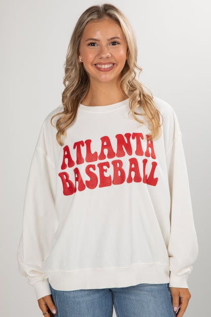 Woman wearing a white sweatshirt with &