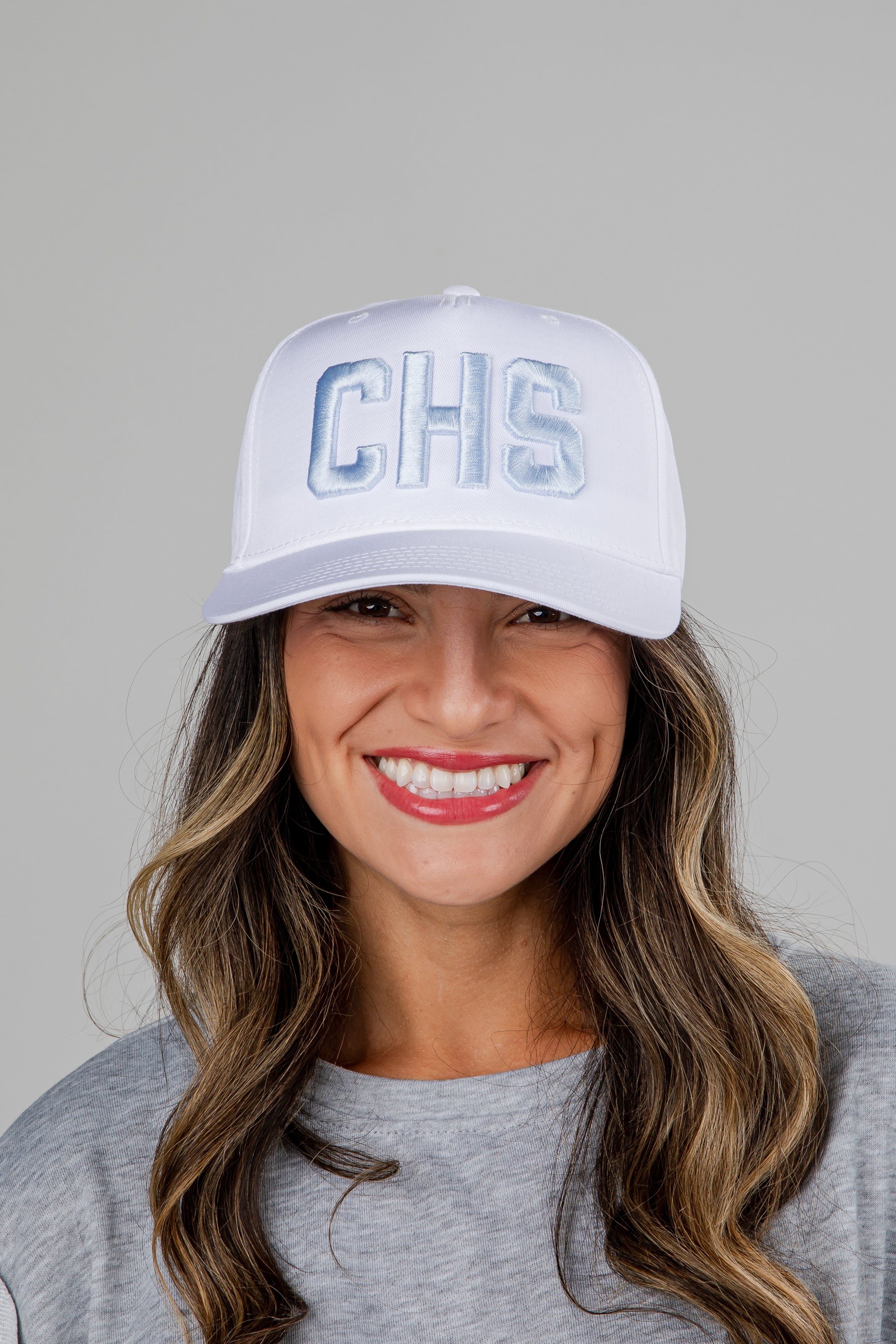 Woman wearing a white cap with &