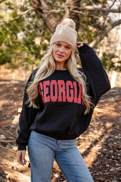 Woman wearing a black sweatshirt with &