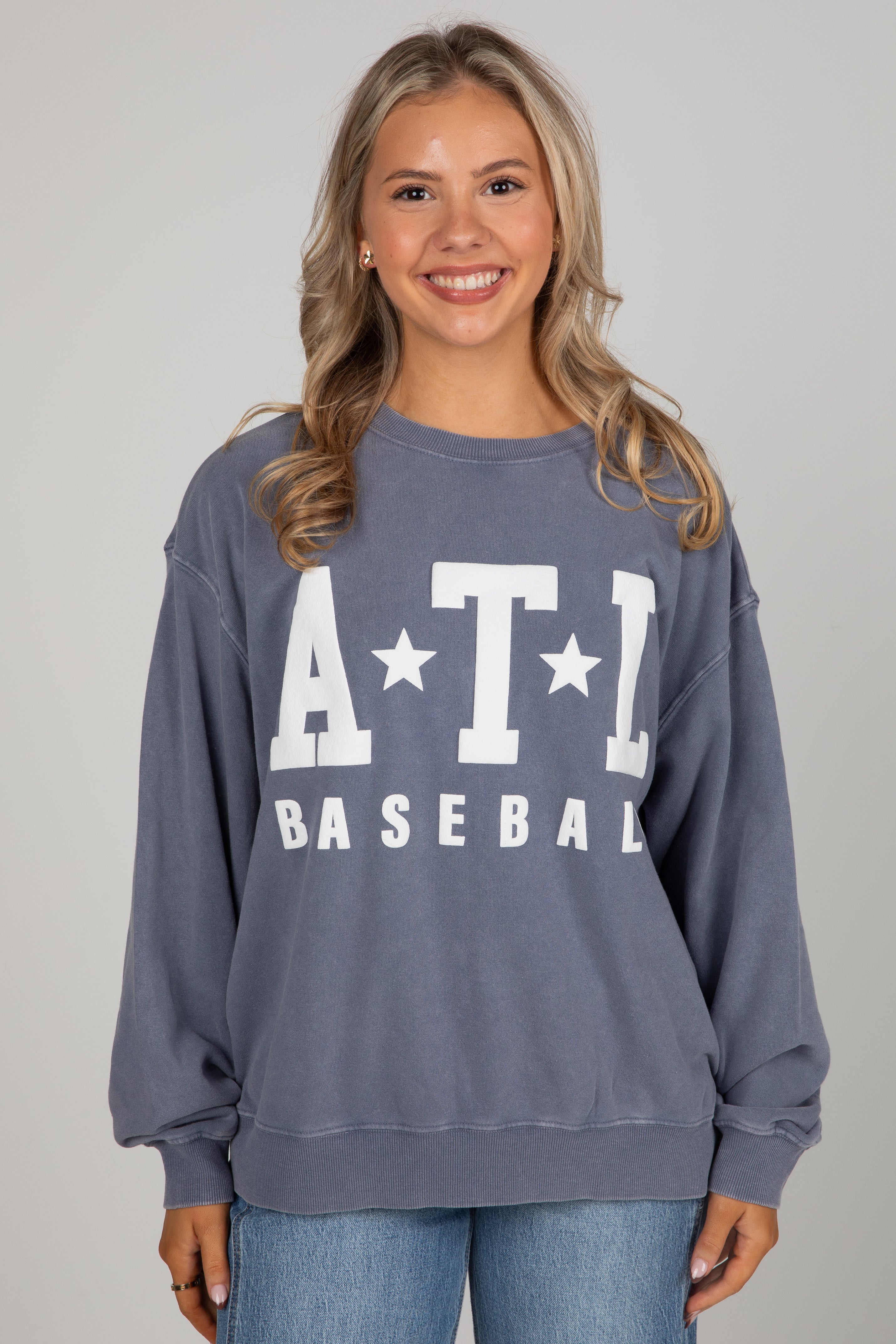 Woman wearing a blue sweatshirt with &