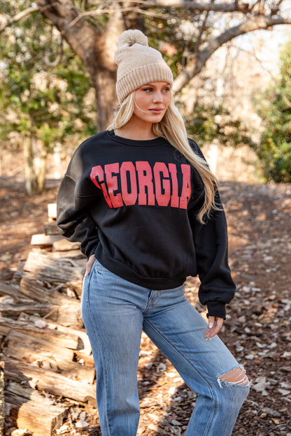 Woman wearing a black sweatshirt with &