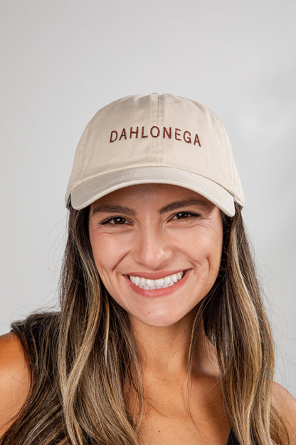 Woman wearing a beige cap with &