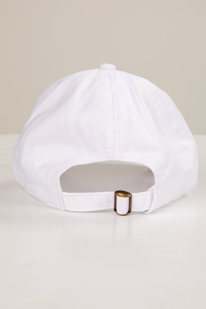 White cap with a gold buckle on a light beige background