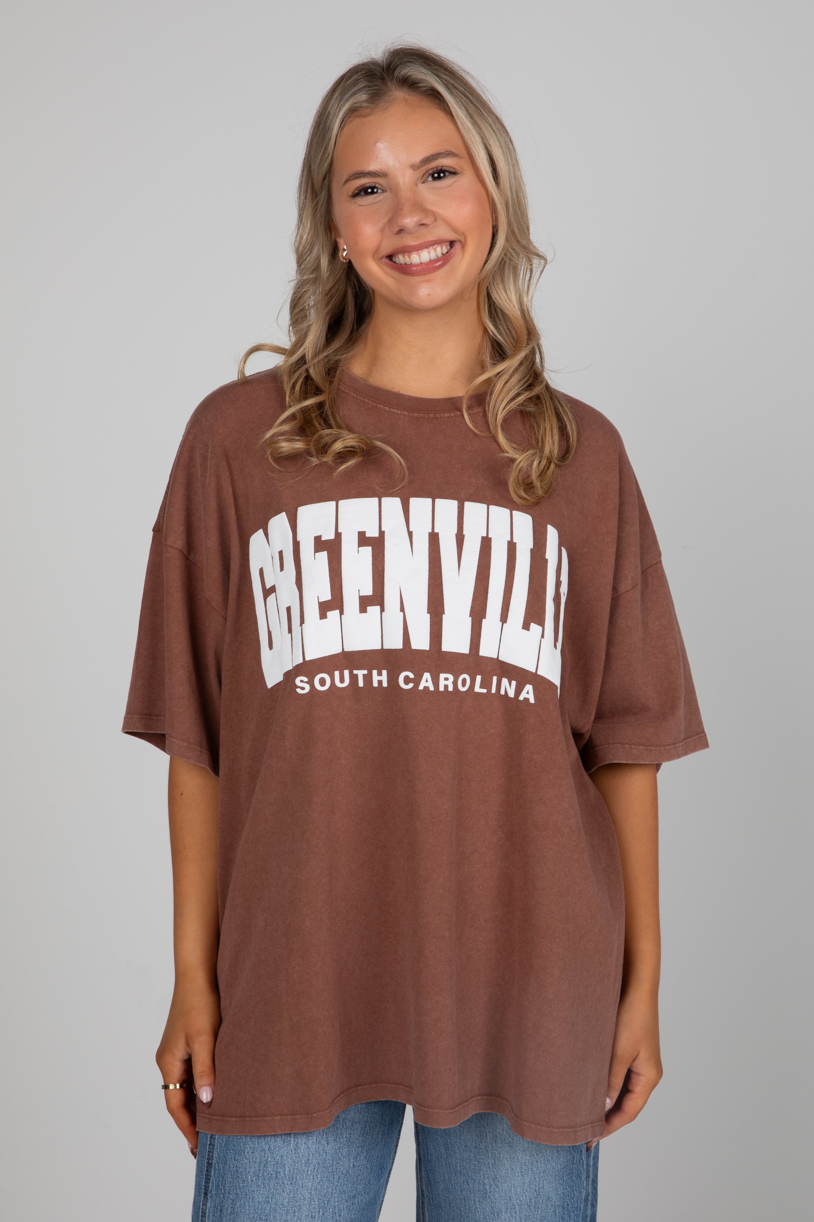 Woman wearing a brown t-shirt with &