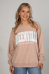 Woman wearing a beige sweatshirt with &