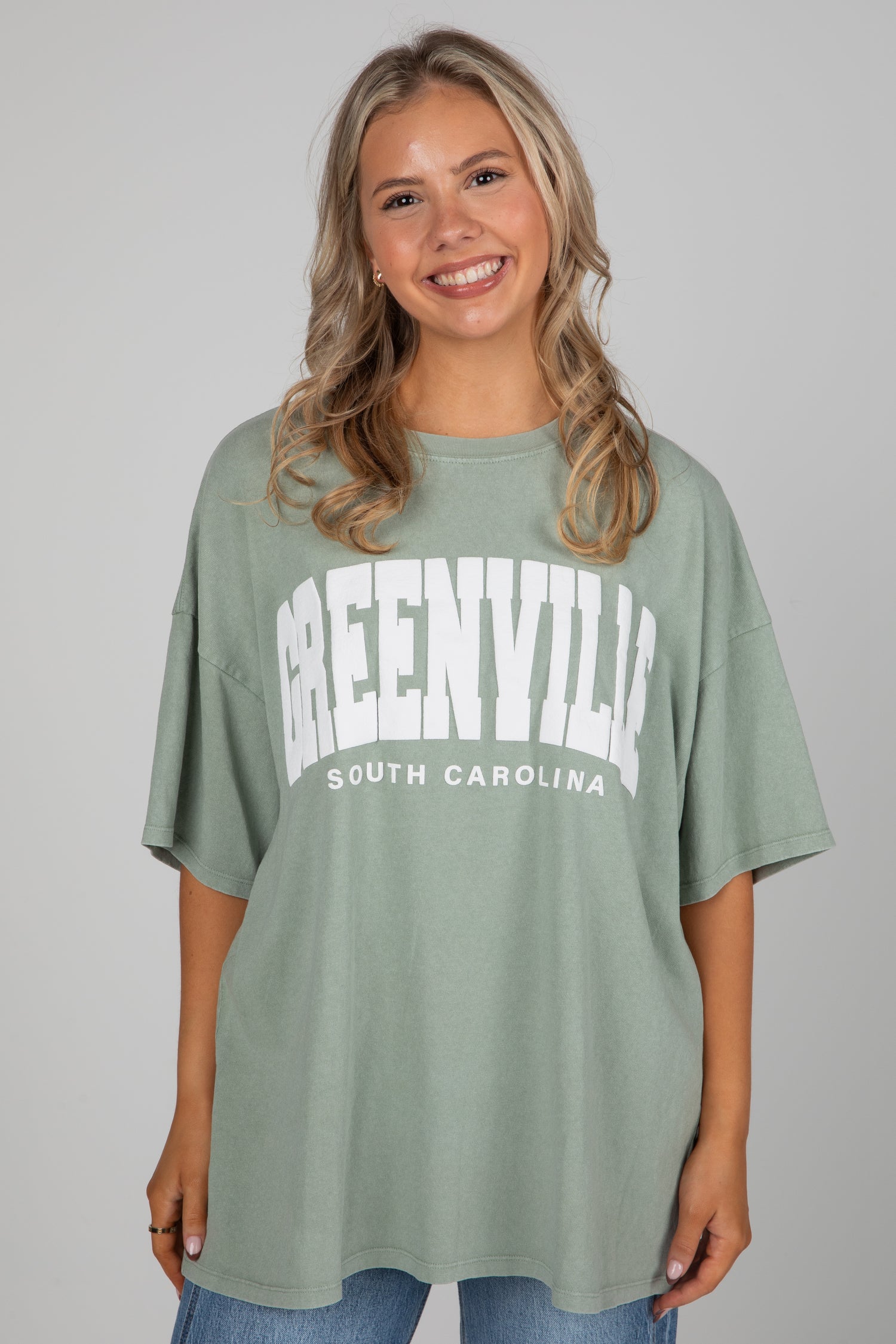 Woman wearing a green t-shirt with &