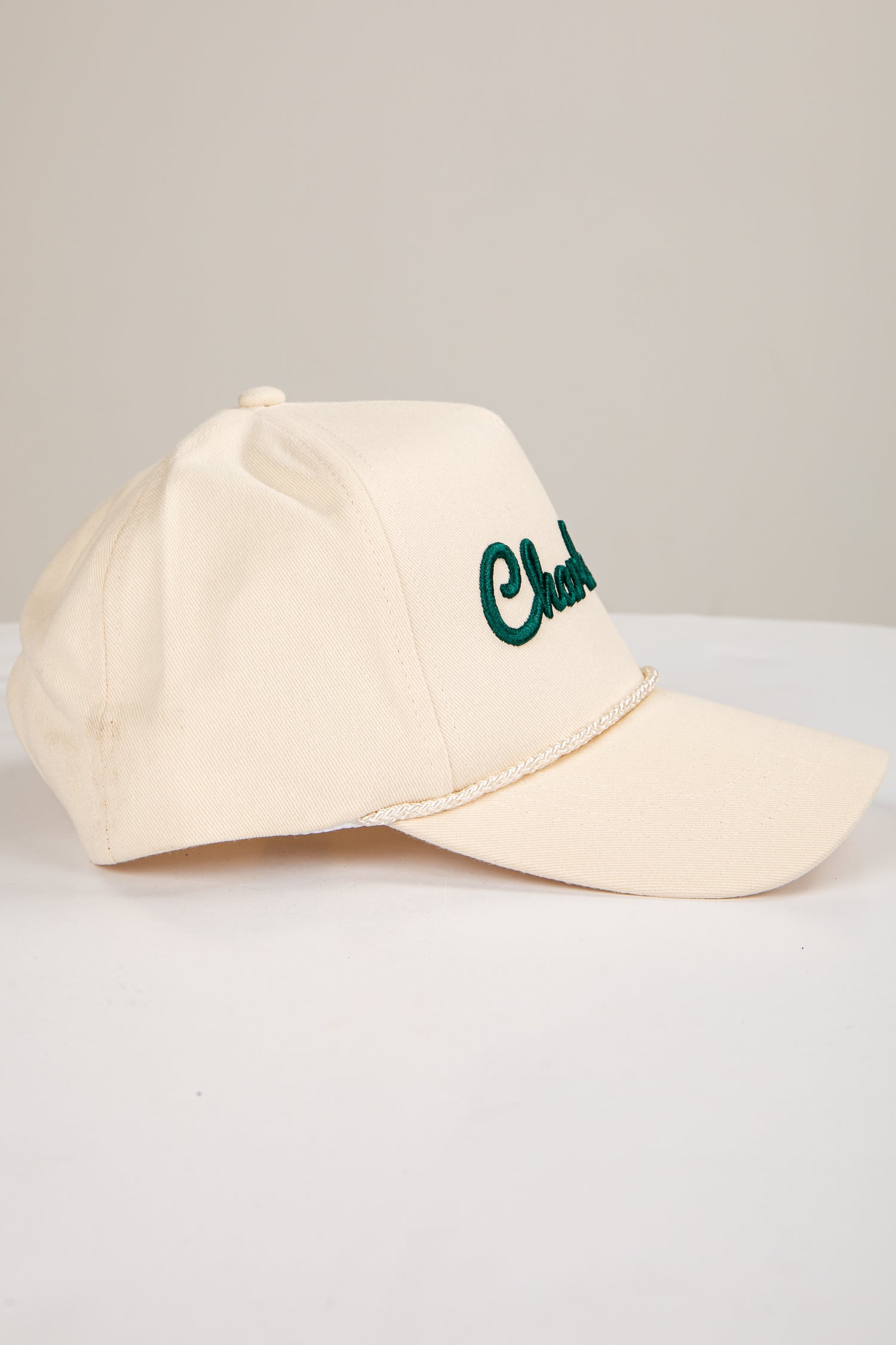 Beige cap with green text on a light gray background