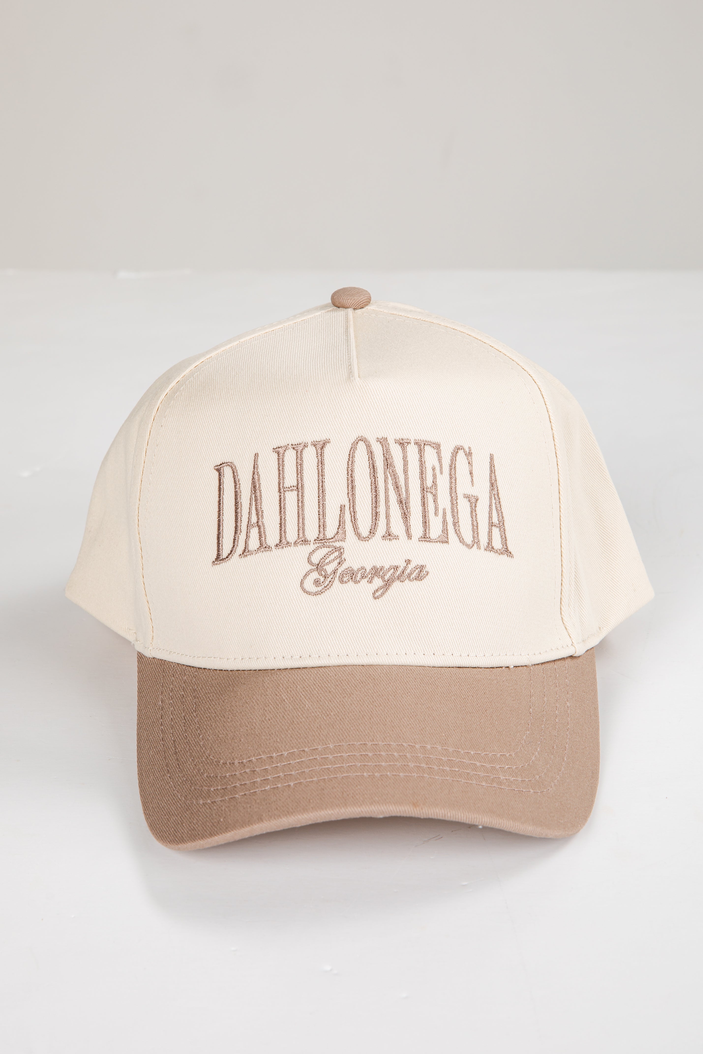 Beige and brown cap with &