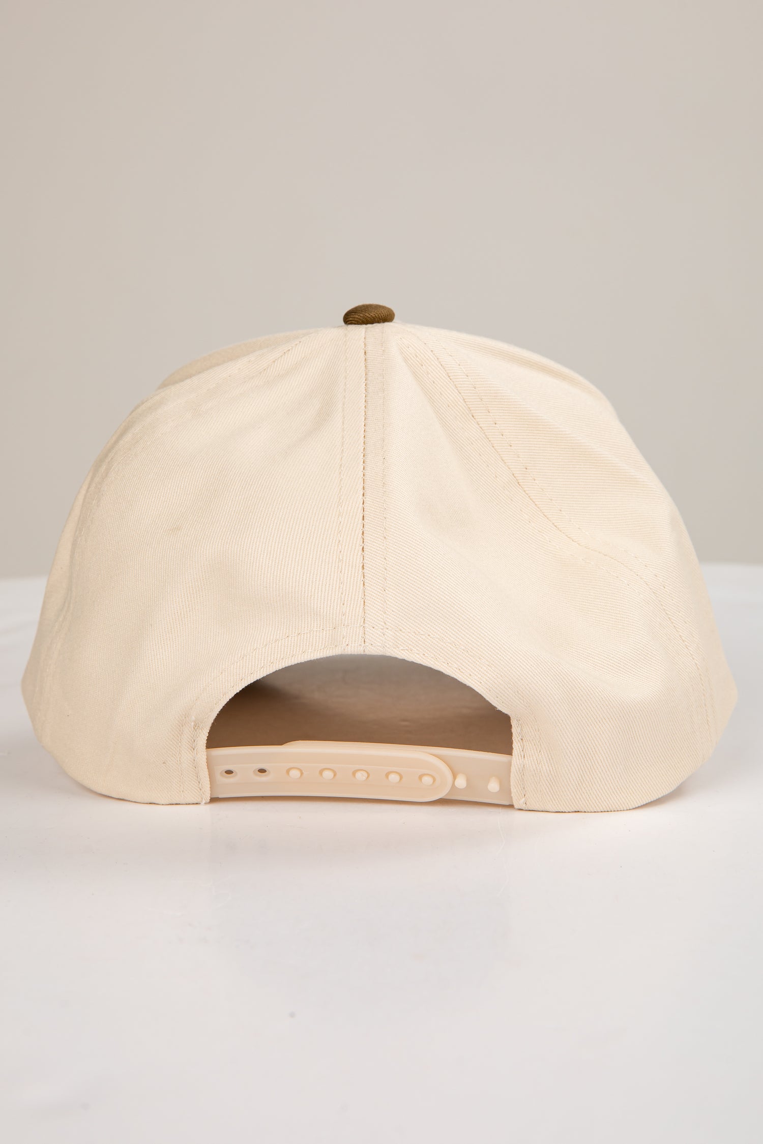 Beige baseball cap on a light gray background