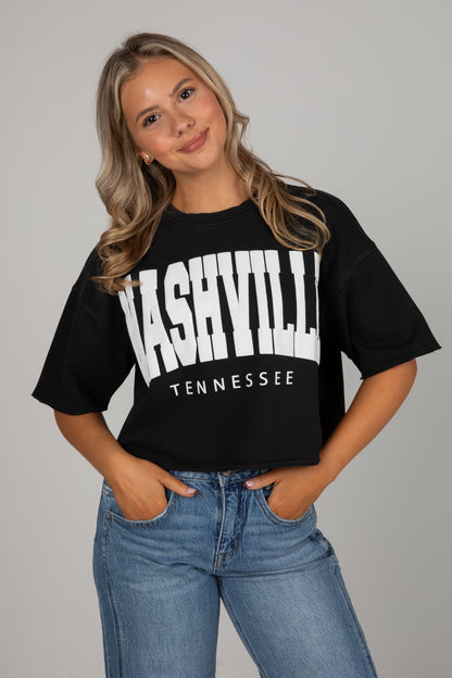 Person wearing a black t-shirt with &