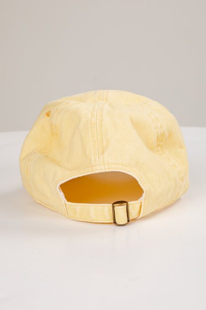 Beige cap with a gold buckle on a white background