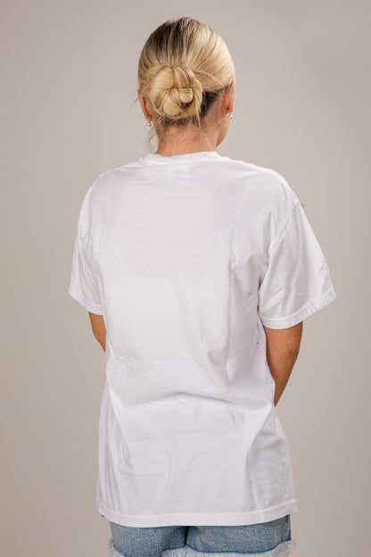Person wearing a plain white t-shirt against a neutral background