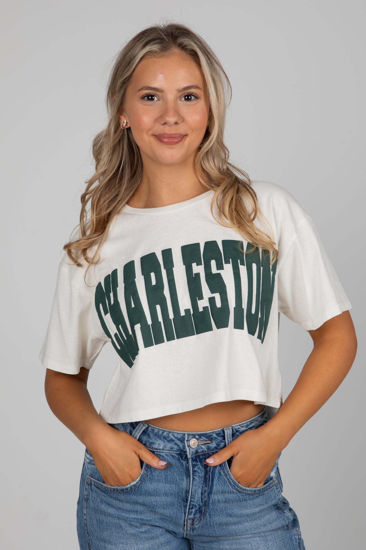 Woman wearing a white crop top with &