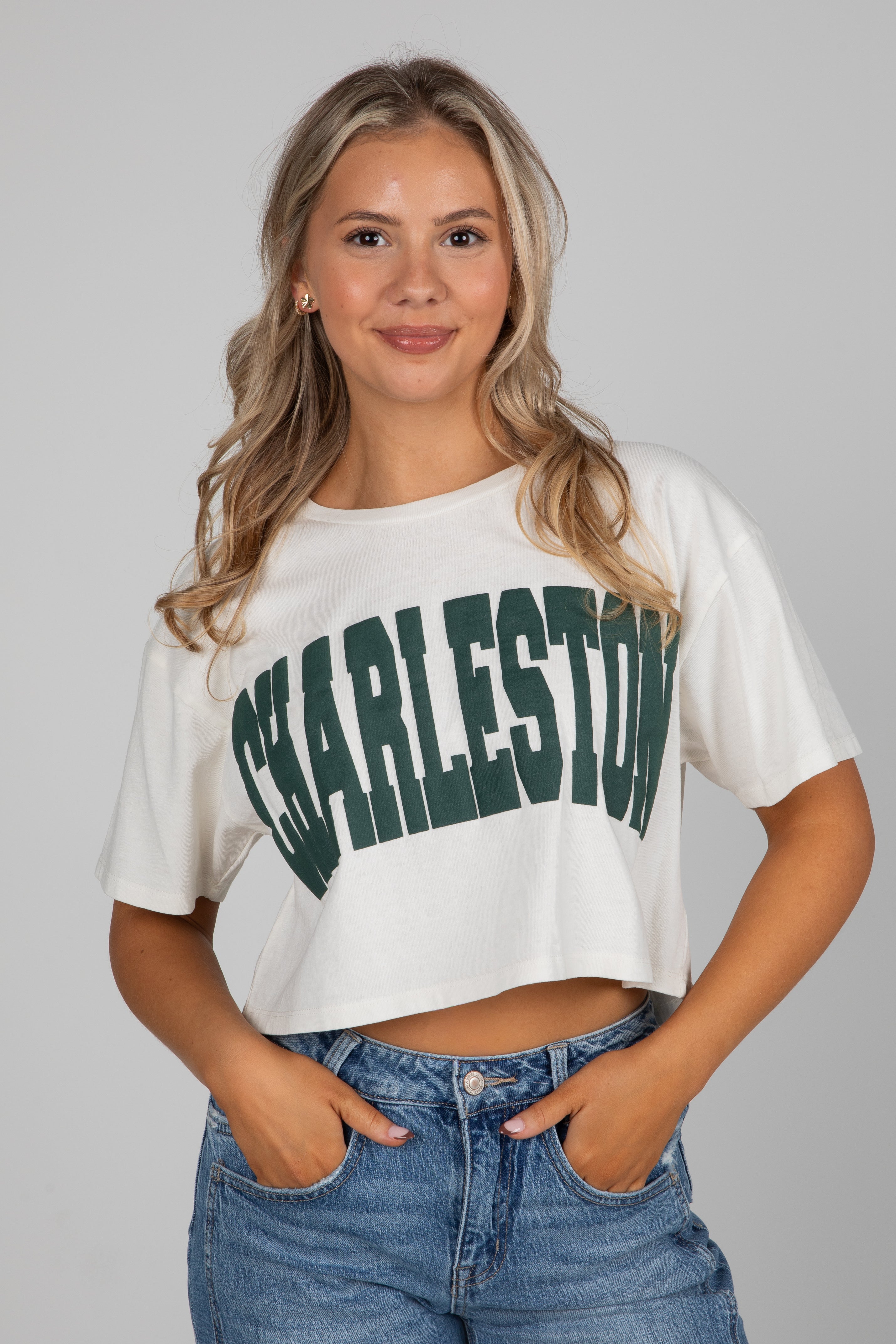 Woman wearing a white crop top with &