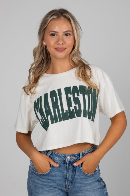 Woman wearing a white crop top with &