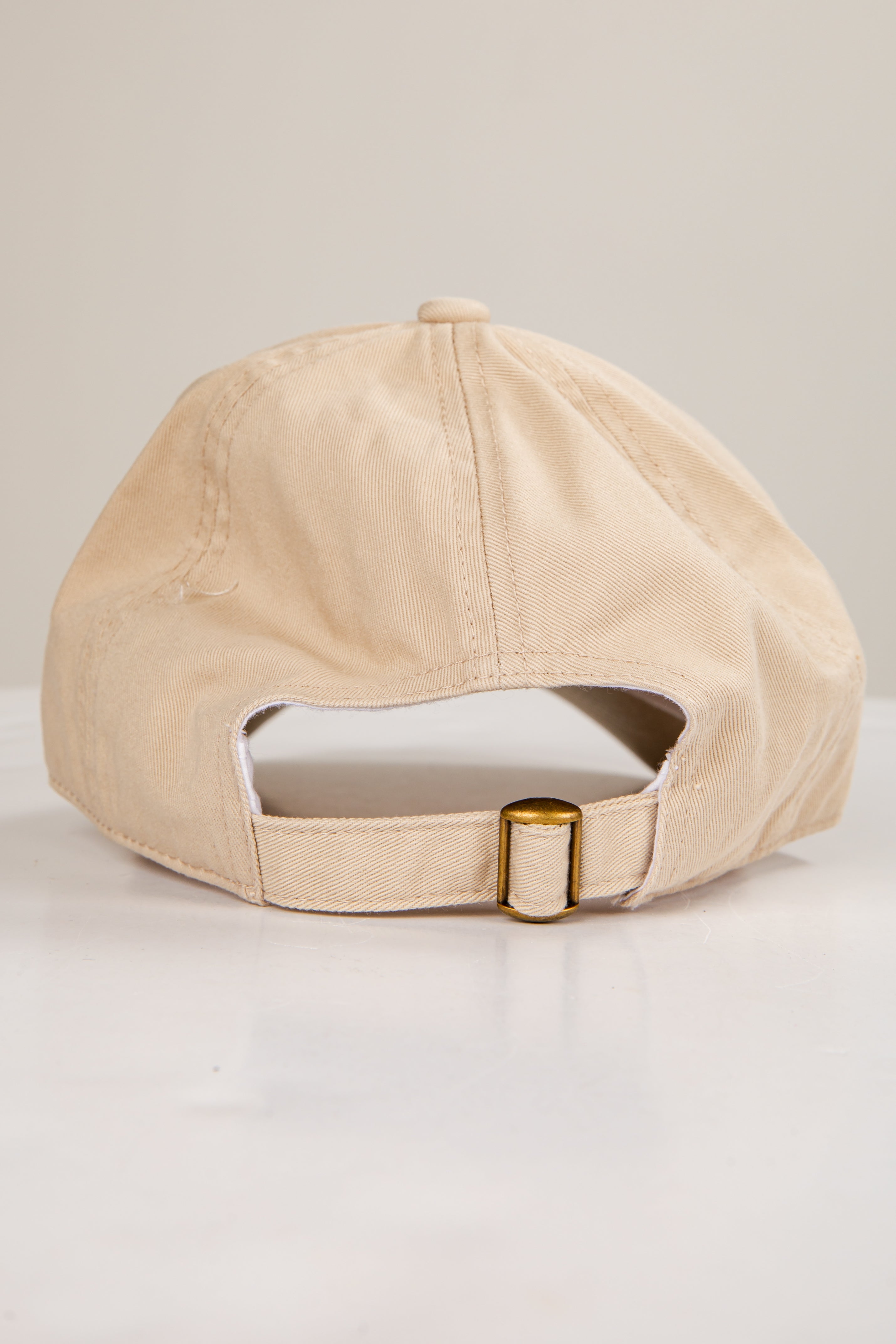 Beige baseball cap on a light gray background