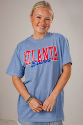 Person wearing a blue t-shirt with &