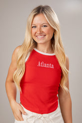 Woman wearing a red tank top with &
