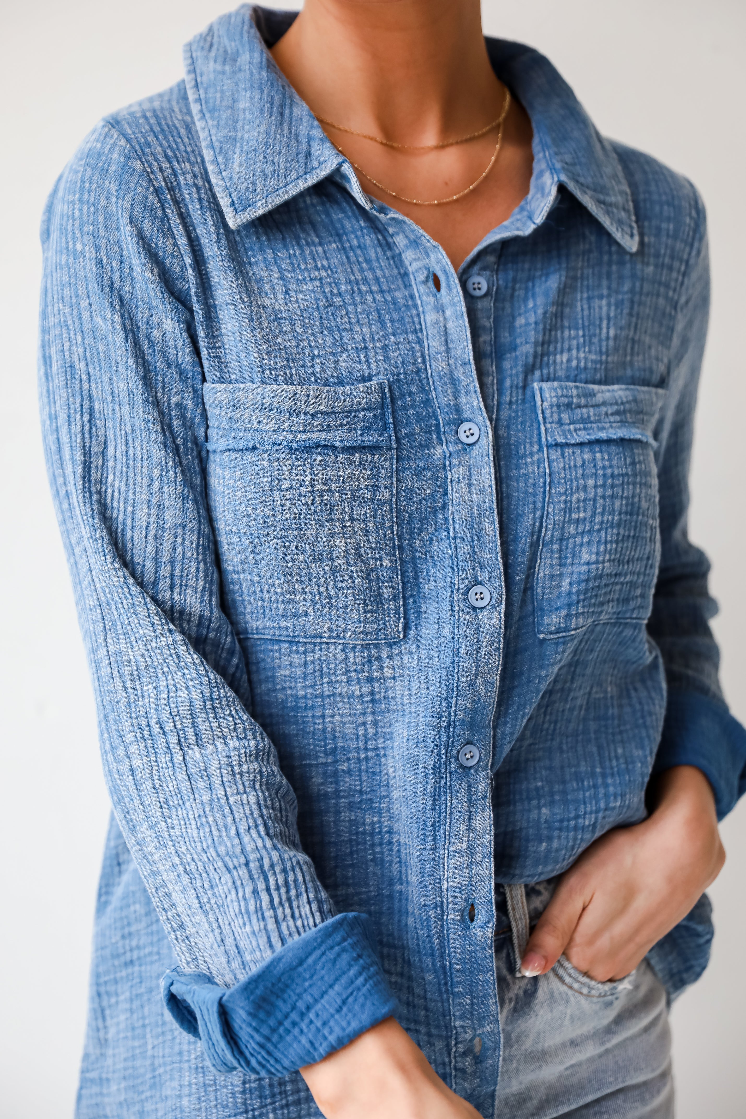 Morgan Denim Linen Button-Up Blouse features, Lightweight Crinkle Linen Fabrication, Acid Washed, Collared Neckline, Functional Button Front long Sleeves with Functional Button Cuffs