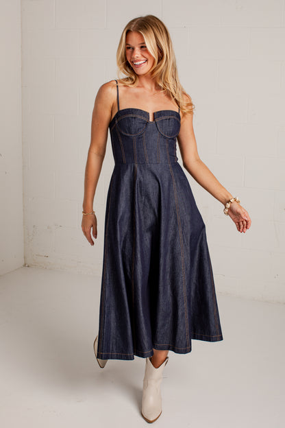 dark-wash dress features a strapless bustier-inspired bodice with defined seaming and a flattering flowy silhouette